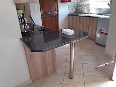 Extended kitchen cupboard with support leg